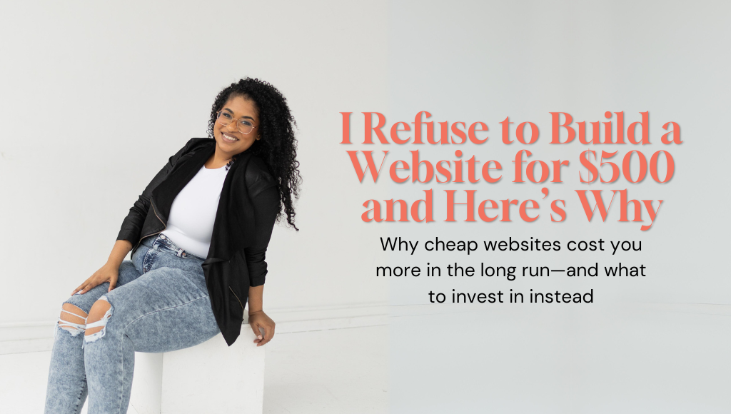 Web designer sitting in a white room wearing a black blazer, white top, and jeans, looking confident and professional.